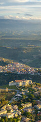 Fototapeta premium Aerial view of the Norman-Swabian Castle, Vibo Valentia, Calabria, Italy. Panoramic view of the valley with the village of Piscopio in the background, the town seen from the air, houses and rooftops