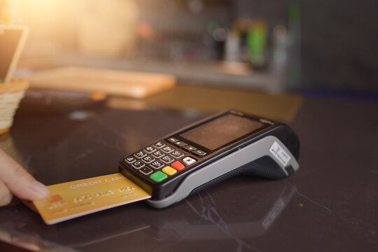 Close-up personal perspective of a Person paying with a  credit card using a credit card terminal