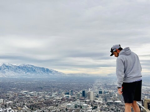 Rear view of a male hiker standing on Ensign Peak looking at the view, Salt Lake City, Utah, USA