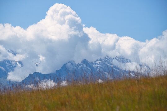 Low clouds over mountain peaks and alpine grasslands near Altdorf, Uri, Switzerland