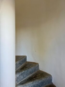 Close-up of concrete steps on a spiral staircase inside a building