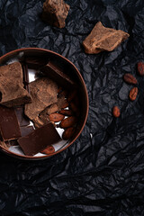 different various  of chocolate with natural cocoa beans at black background