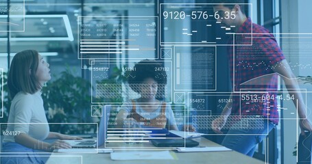 Discussing team wearing business wear reviewing data at office with laptops, phone, HUD overlays