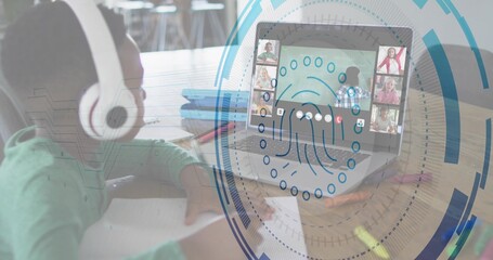 Writing kid wearing white headset and green top at study table, using laptop notebook biometric HUD