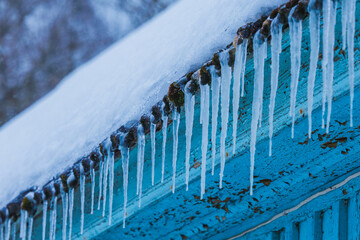 Icicles on the roof of the house. Danger of falling