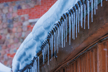 Icicles on the roof of the house. Danger of falling