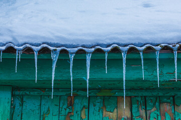 Icicles on the roof of the house. Danger of falling