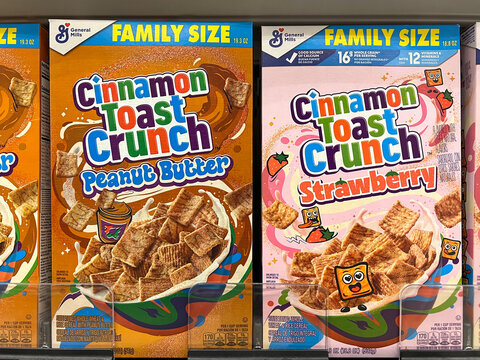 Alameda, CA - Feb 2, 2026: Grocery store shelf with boxes of General Mills brand cereal Cinnamon Toast Crunch. New Peanut Butter and Strawberry flavors.