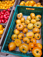 Large yellow tomatoes at grocery shop
