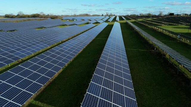 Aerial close up drone view of solar power panels featuring detailed photovoltaic cells for renewable energy generation from sunlight.