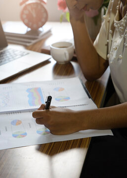 Business and Financial Planning Concept. Financial advisor planning and working on laptop. Professional Businesswoman discusses and review annual report at office-vertical image