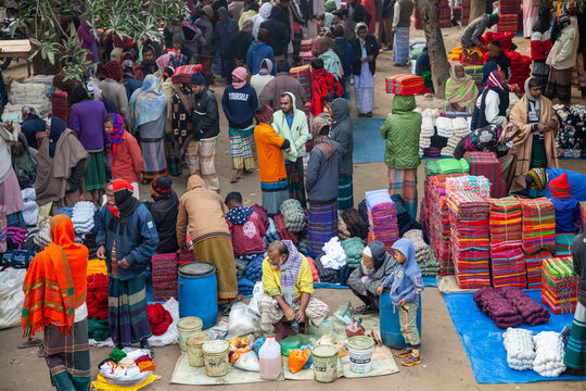 Sirajganj, Bangladesh - 10 January 2025: View of a bustling marketplace, a vibrant tapestry of colours as people trade goods amidst a lively atmosphere.