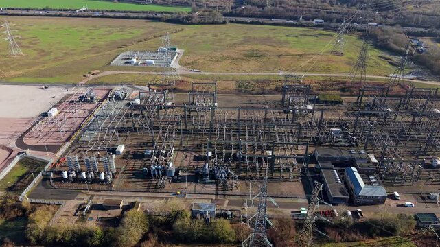 High angle aerial drone view of a large National Grid electrical substation and battery storage BESS units in Luton United Kingdom.