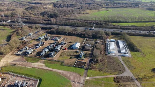 High angle aerial drone view of a large National Grid electrical substation and battery storage BESS units in Luton United Kingdom.