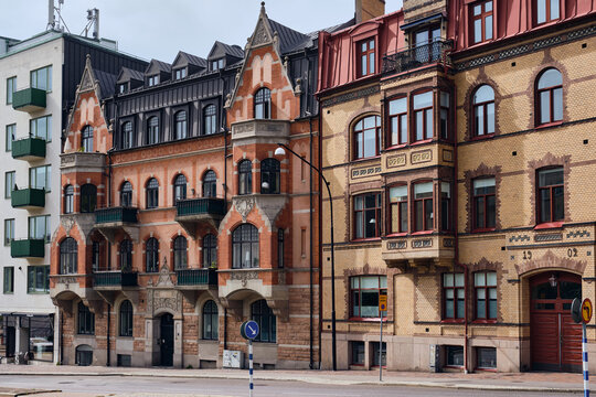 Helsingborg, Sweden - 12 August 2025: View of brick buildings with detailed facades, their red and yellow hues contrasting against the overcast sky.