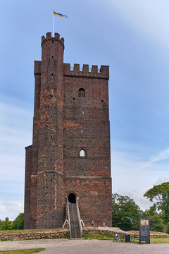 Helsingborg, Sweden - 12 August 2025: View of Karnan tower's dark brick contrasting against the soft blue sky, a silent sentinel overlooking the landscape.