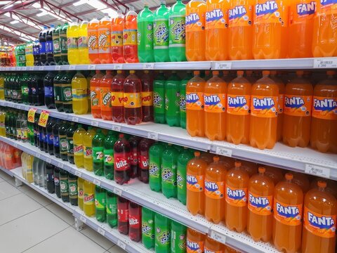 Puerto Natales, Chile - July 10th 2025: Carbonated beverages arranged on multiple store shelves, highlighting product abundance, variety, and shopping experience in a grocery aisle