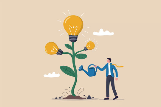 Businessman watering a plant with light bulbs growing as fruit representing innovative ideas and growth