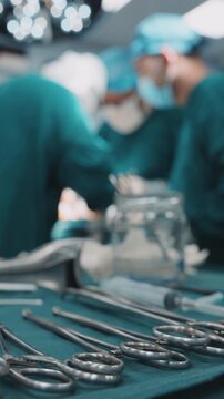Surgical instruments in the operating room during operation. Professional healthcare teamwork. Vertical shot