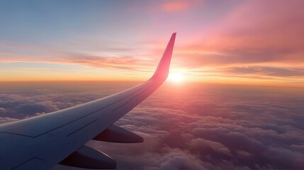 Obraz premium A stunning sunset casts vibrant colors over the clouds, viewed from an airplane wing, showcasing the beauty of nature and the thrill of flying through the sky.