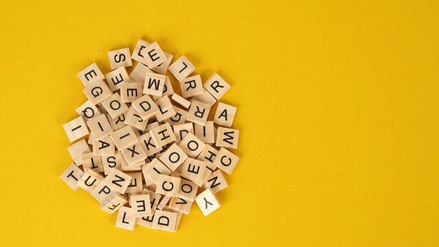 wooden cube words game isolated on yellow background