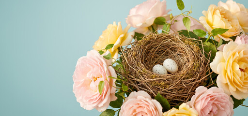 Bird's Nest with Speckled Eggs in Floral Bouquet on Soft Blue Background
