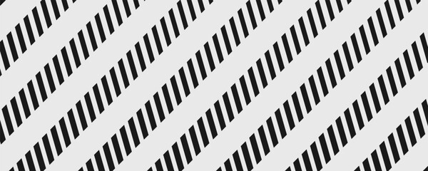 Abstract black diagonal stripes pattern on gray background. Forming geometric texture with high contrast lines and dynamic repetition.v