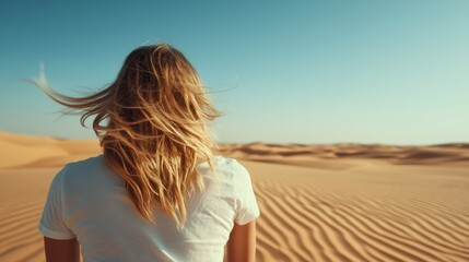 Fototapeta premium A serene scene depicting a woman with flowing hair standing in a vast desert landscape during golden hour, capturing feelings of solitude and freedom in nature's beauty.