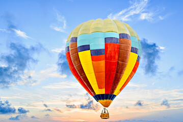 Fototapeta premium Colorful hot air balloon flying over blue sky with white clouds