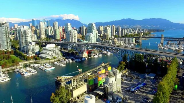 Breathtaking Aerial Shot of Vancouver skyline, Burrard Street Bridge, and False Creek. False Creek and the Vancouver city skyline at sunrise, British Columbia, Canada. majestic North Shore Mountains u