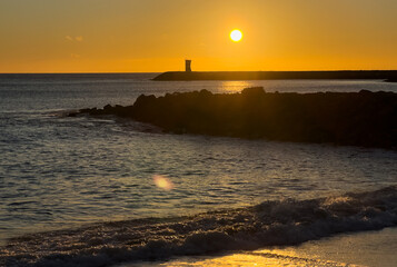  red and white harbour lighthouse on rocky breakwater at entrance channel to Marina de Vilamoura, next to Vilamoura Beach in Quarteira, Loule, Faro district, Algarve, Portugal