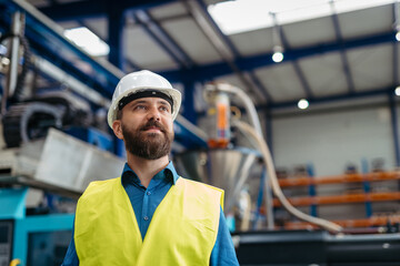A portrait of project manager or engineer a factory, working.