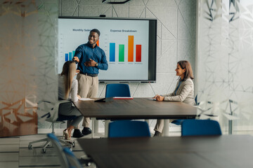African american businessman giving presentation to colleagues