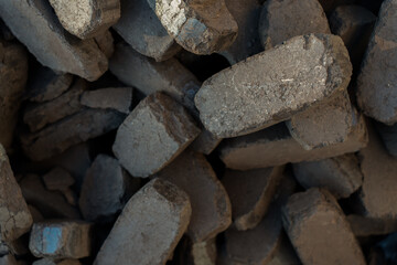 Charcoal briquettes used for barbecue. Charcoal for hookah, pieces of charcoal for water pipes in close-up. An industrial pile of briquettes, bricks.