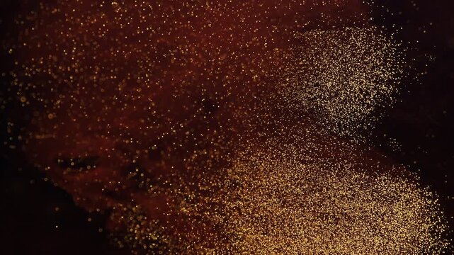 Abstract macro motion of tiny golden bubbles and glitter particles rising from the corner in dark liquid. Elegant fluid transitions with shimmering gold dust and organic shapes.