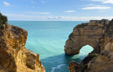 Natural arches underneath rugged cliffs, Praia da Marinha, Algarve, Portugal, Europe