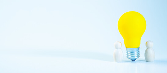 Idea concept with yellow light bulb and people figure on blue background