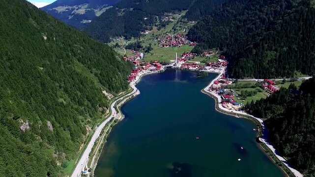 Aerial view of Uzung&ouml;l lake and mountains in Trabzon, Turkey. deep green, mirror-like water surrounded by steep, lush forested mountains and the charming village. Turkish tourism, nature documentaries