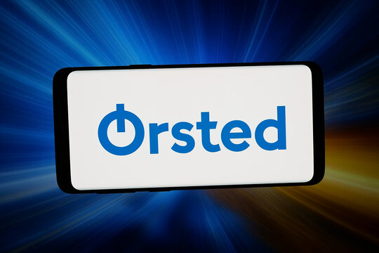 Stuttgart, Germany - 02-14-2026: In this photo illustration, the logo of Danish energy Orsted AS is displayed on a smartphone in front of abstract background on computer screen.