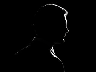 businessman silhouette with rim lighting isolated on a black background