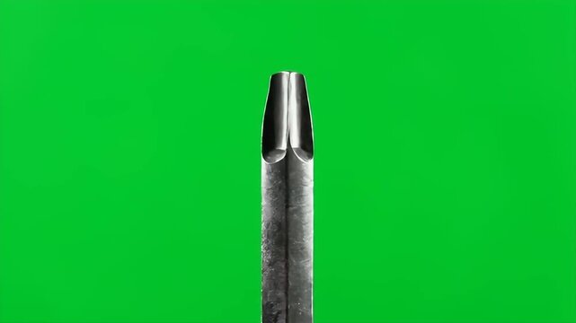 Sharp close-up of a metallic tool tip on vivid green for construction and repair videos