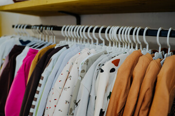 Children's clothing store. Sale in a children's clothing store. Beautiful and bright children's clothing. Lots of nice clothes for kids. Printed clothing. Sweatshirts for children.