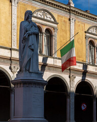 Statue of Dante Alighieri and Italian flag in Verona, Italy