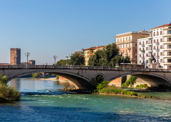Historic bridge over Adige River and medieval tower in Verona, Italy