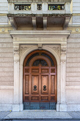 Ornate wooden door and historic facade in Verona, Italy