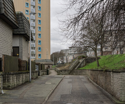 Architectural view of residential buildings and bare trees in Torry Aberdeen City Scotland under a gray sky