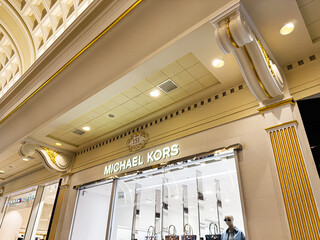 Naklejka premium Luxurious fashion Michael Kors store at The Trafford Centre, Manchester, UK showcasing handbags and mannequins