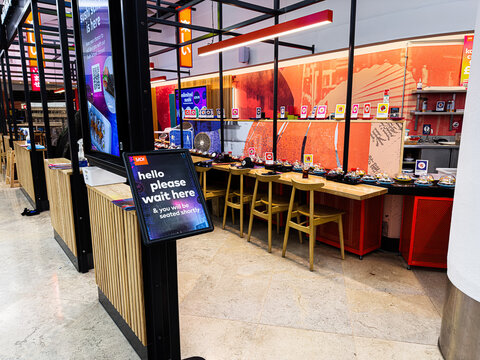 Sushi restaurant seating area with patrons at The Trafford Centre in Manchester, UK