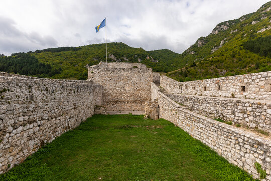 Travnik Fortress historic stone walls and Bosnian flag, Bosnia and Herzegovina.
