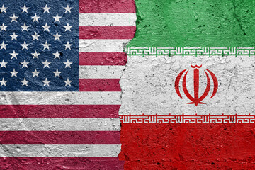 United States of America vs Iran - Cracked concrete wall painted with a USA flag on the left and a Iranian flag on the right stock photo